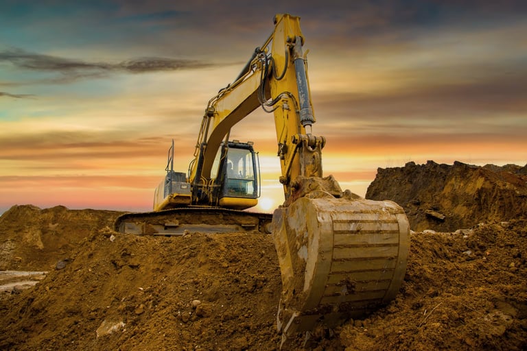 Excavator on sunset. Heavy construction equipment on excavation on construction site